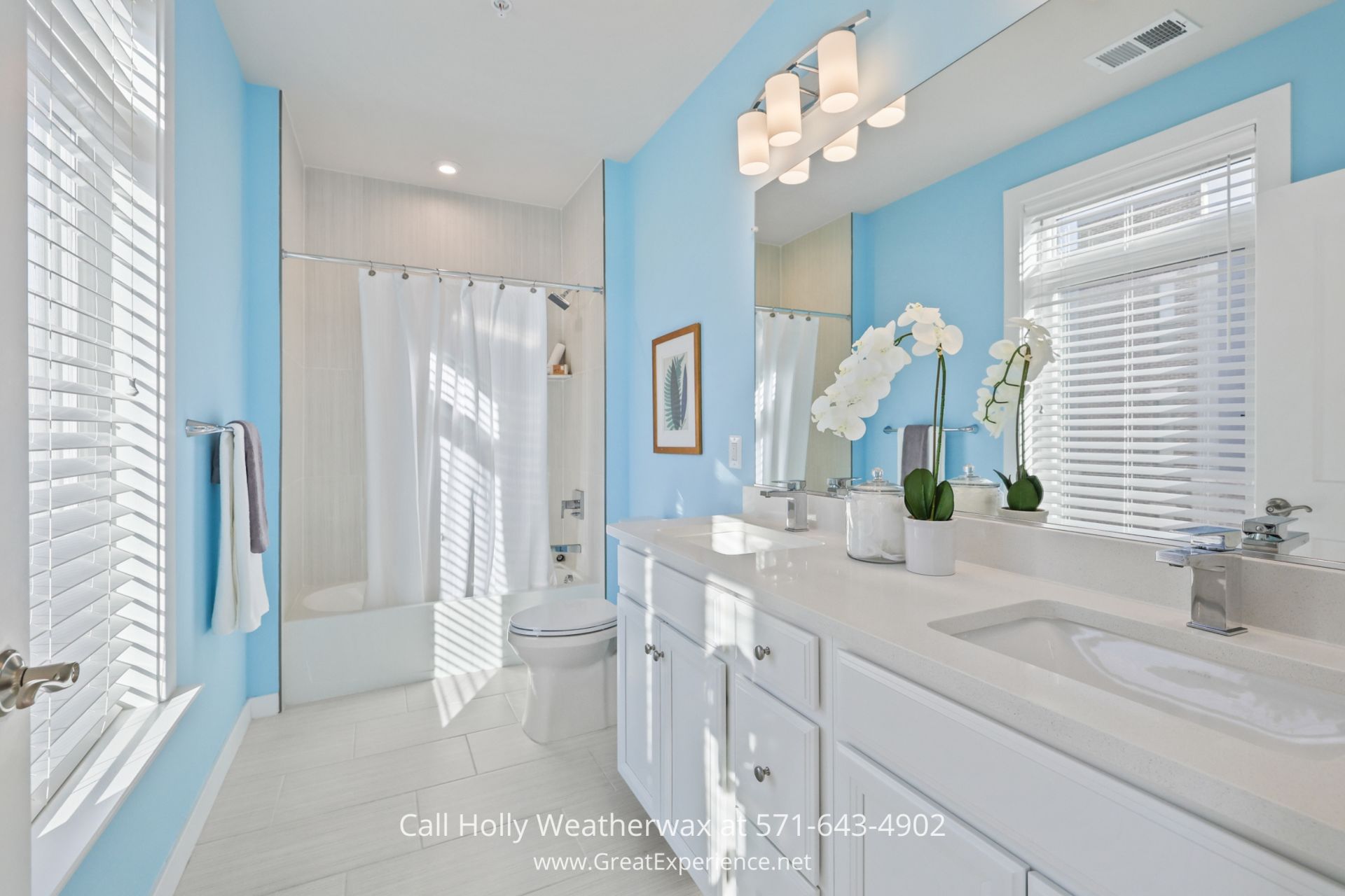 Home for Sale in Reston - Pretty and modern bathroom in Reston VA condo with high-quality fixtures and spa-like atmosphere a bathroom with blue walls and white fixtures