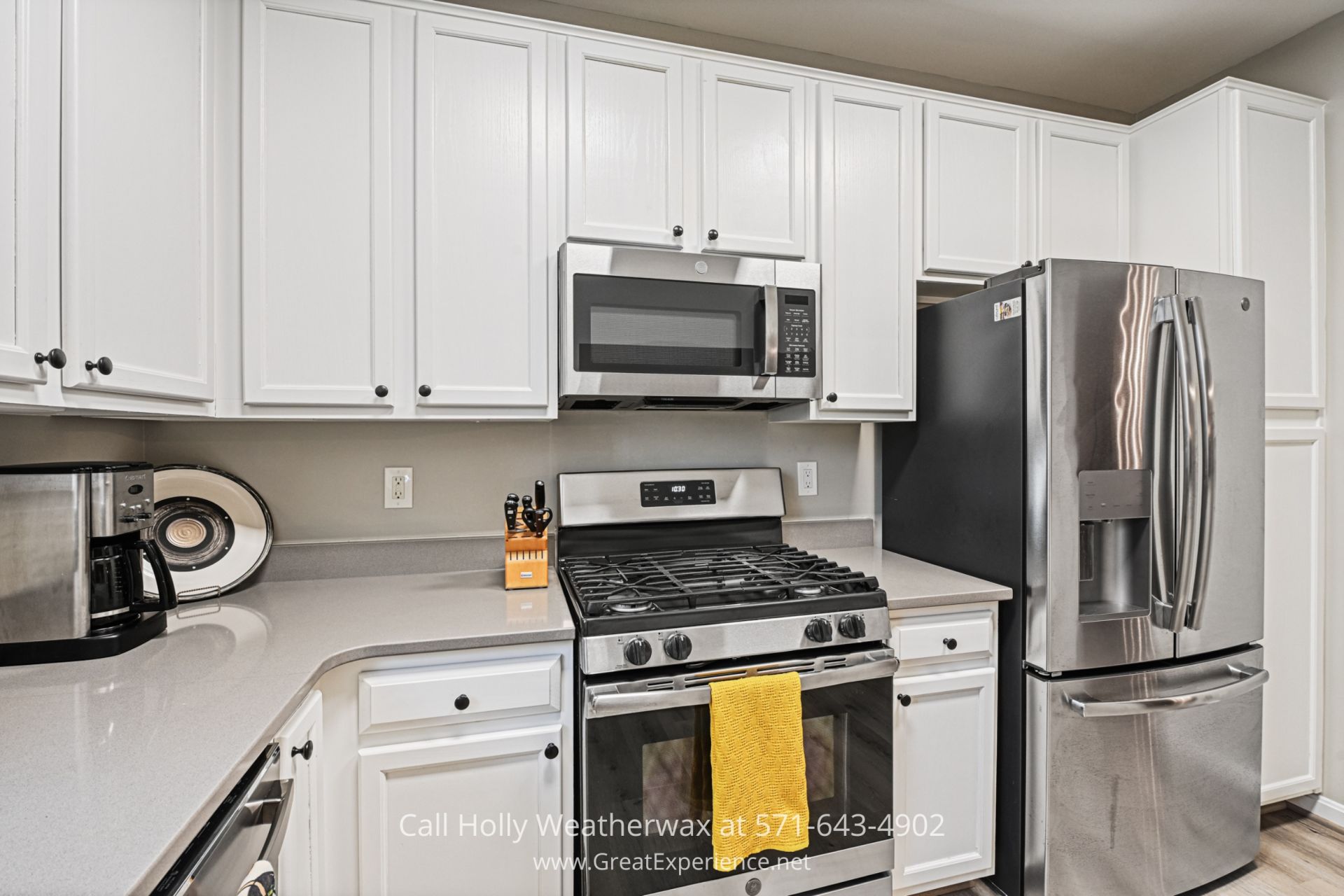 Reston VA Condo for Sale a kitchen with white cabinets and stainless steel appliances