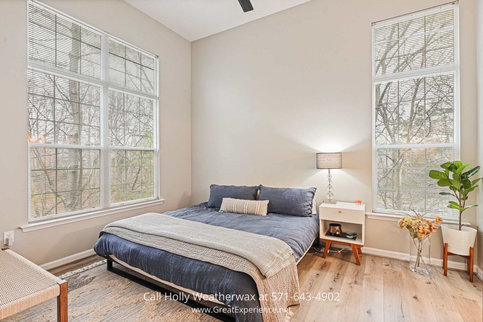 Reston VA Condominium a bedroom with a bed and two windows