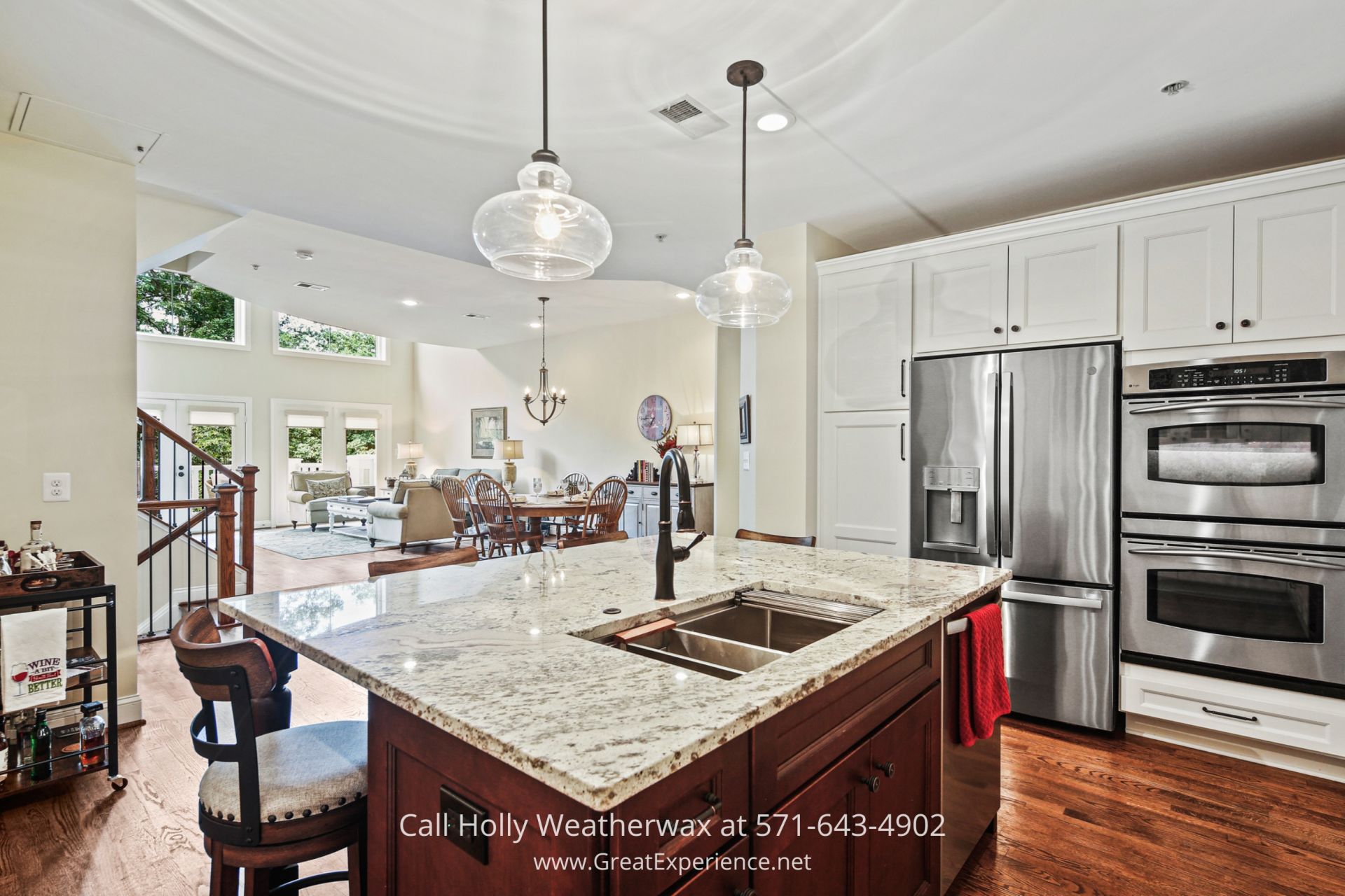 a kitchen with a large center island with a sink