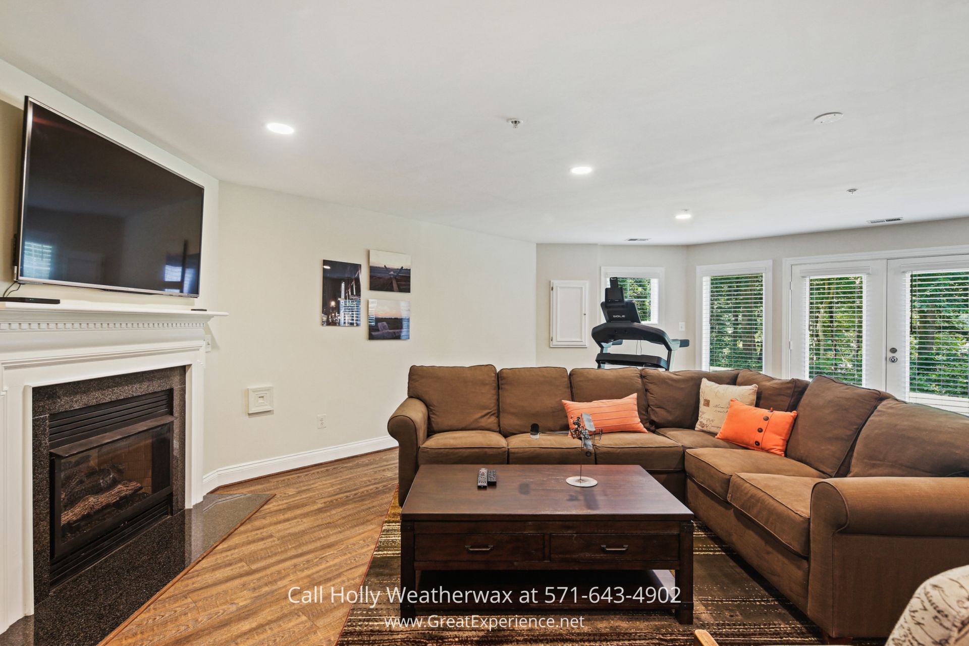 a family room filled with furniture and a flat screen tv