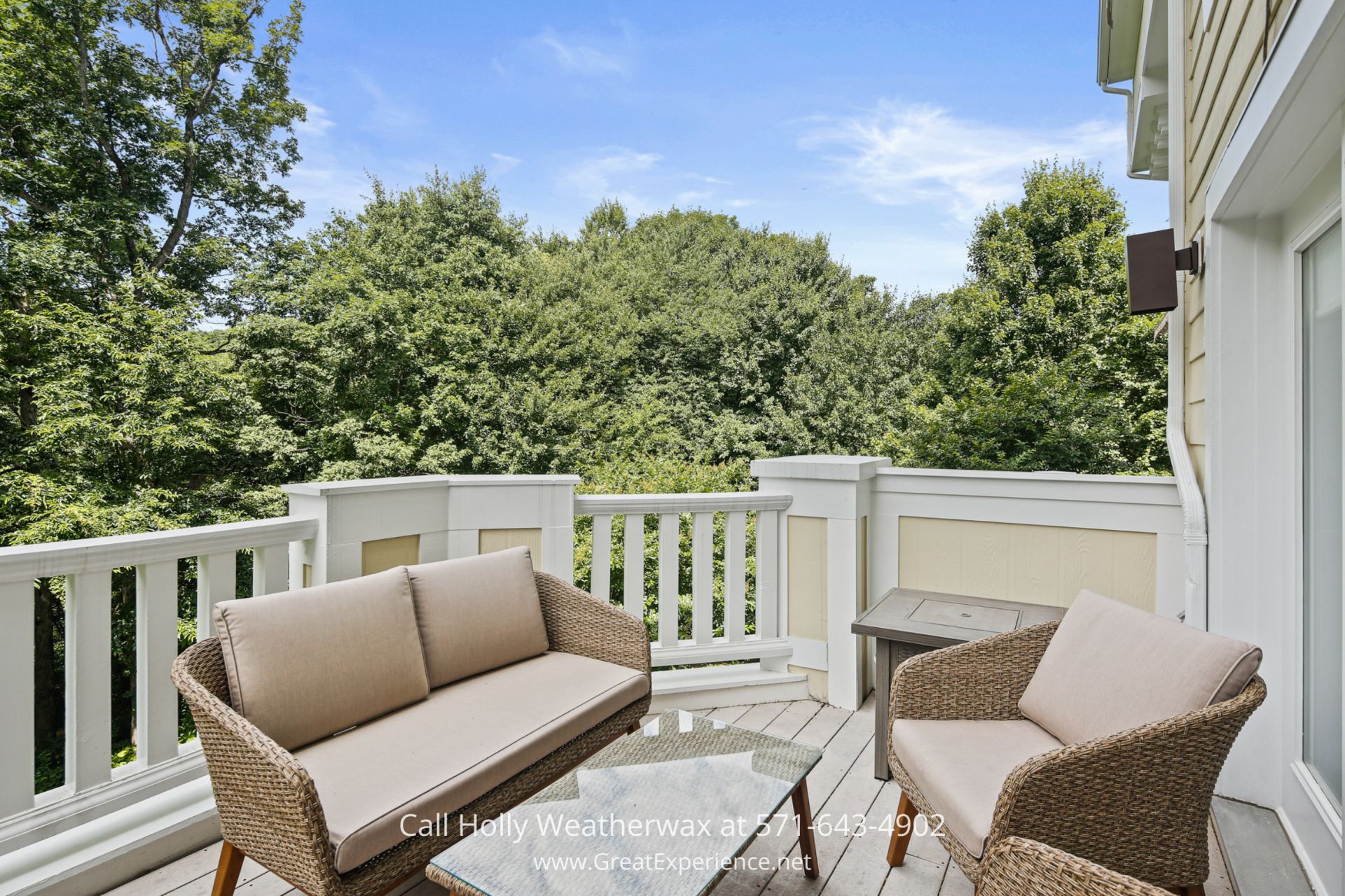 a porch with two chairs and a couch on it