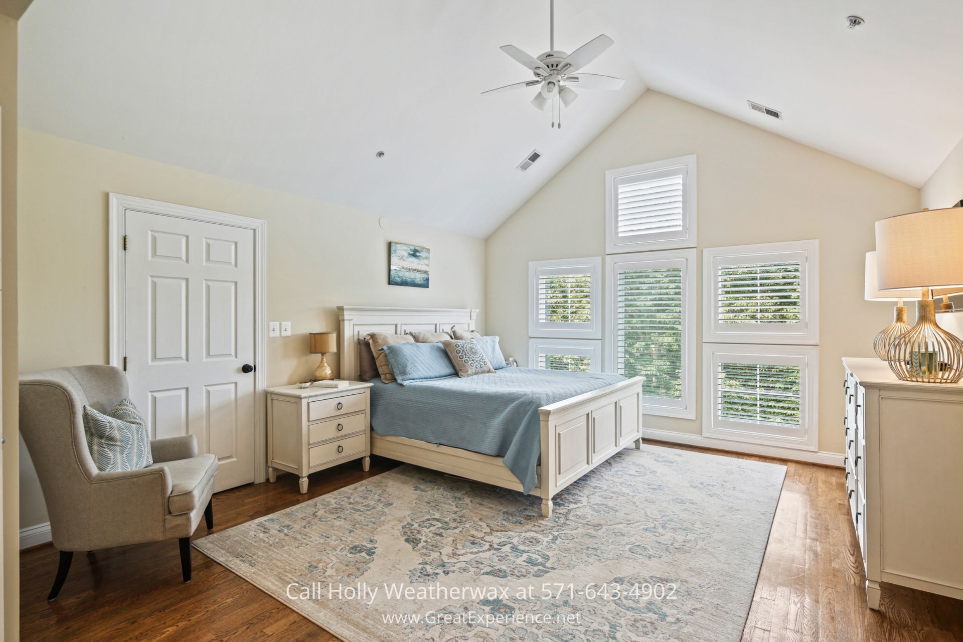 a bedroom with a neatly made bed and a chair