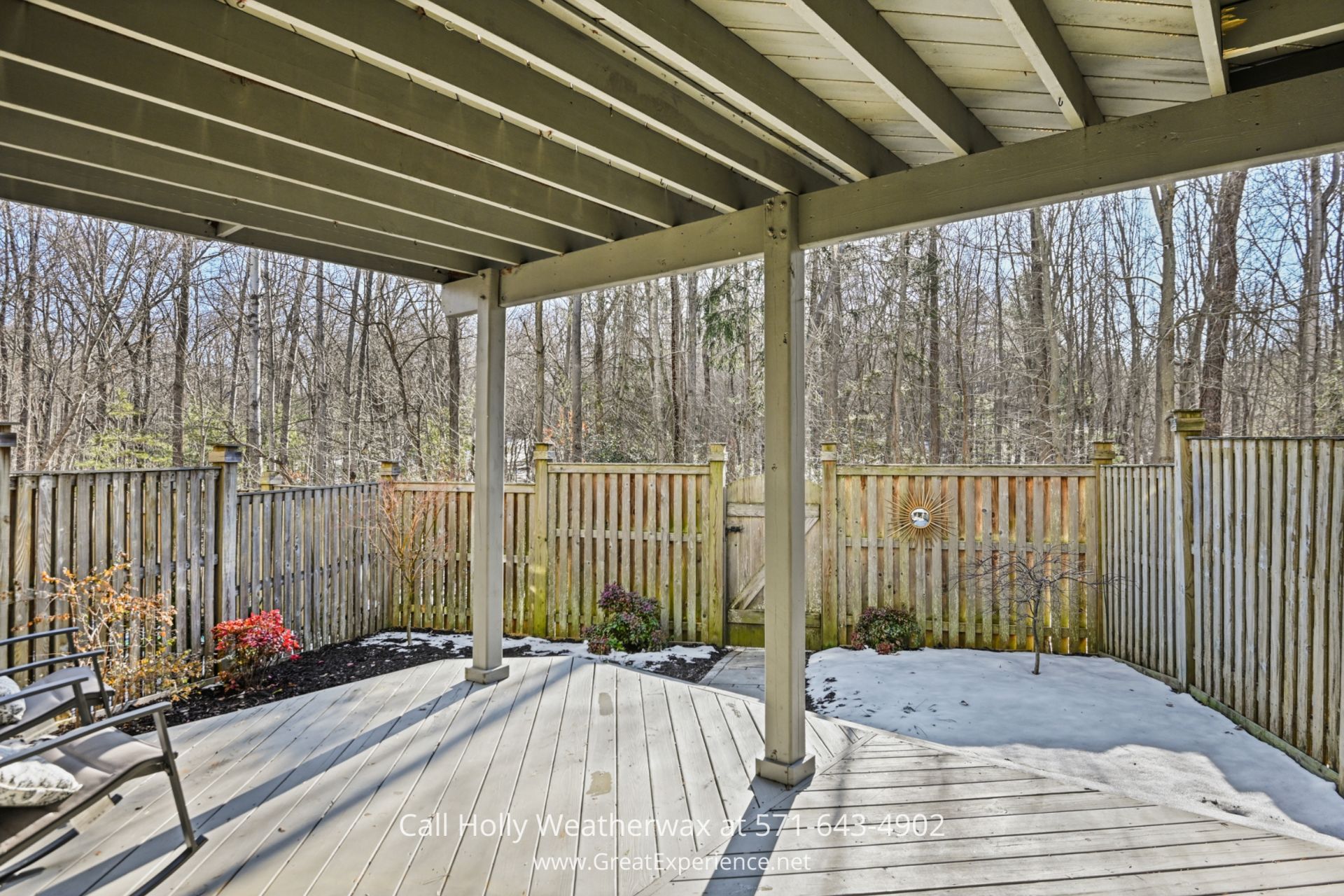 Private Outdoor Space in Reston VA Townhouse A fenced outdoor space with wooden decking, comfortable seating, and a natural backdrop of trees, offering a peaceful and private retreat.