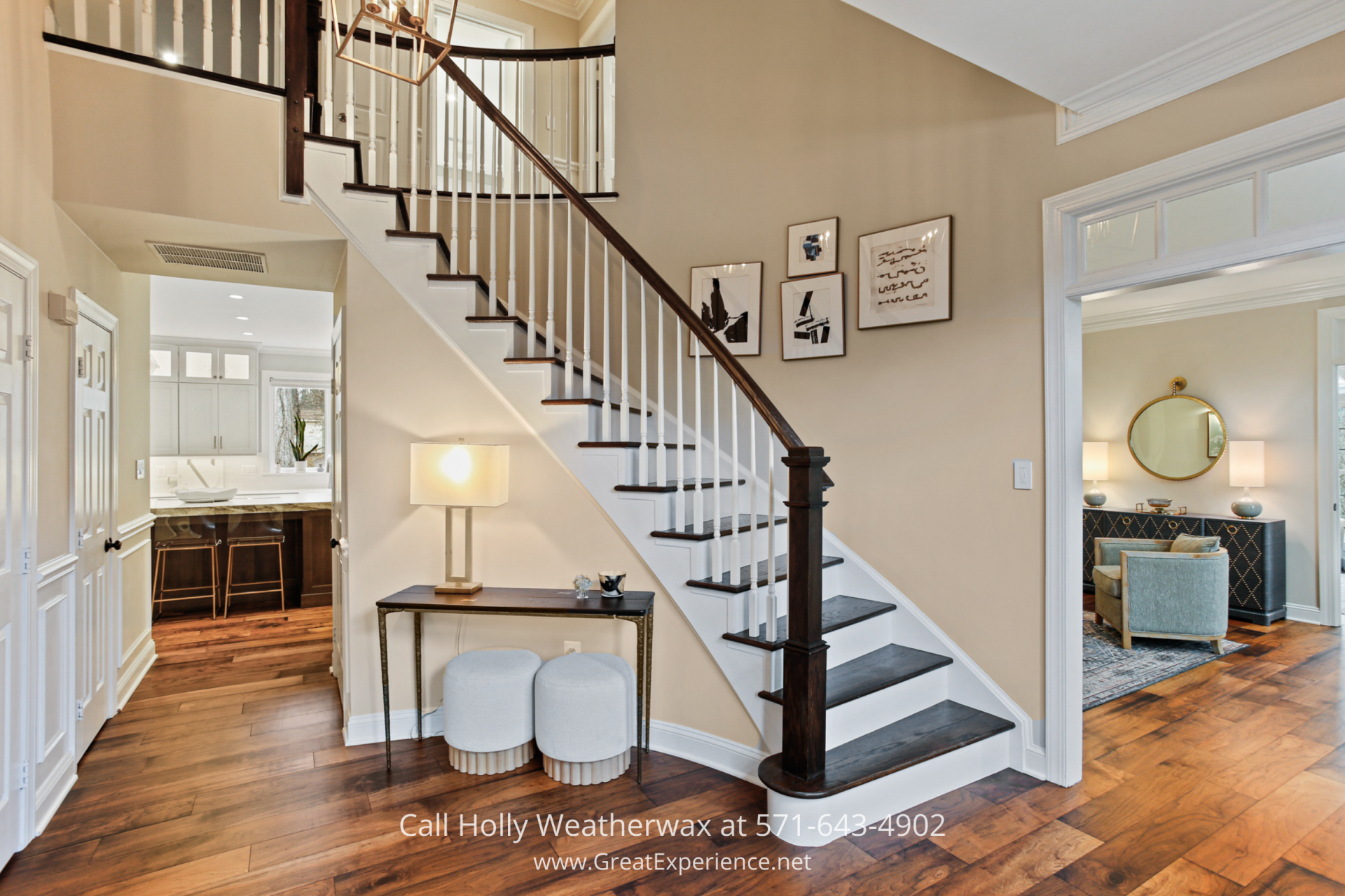 Grand foyer at 1110 Round Pebble Lane, Reston, VA, featuring a curved staircase, hardwood floors, and open entry to main living spaces.
