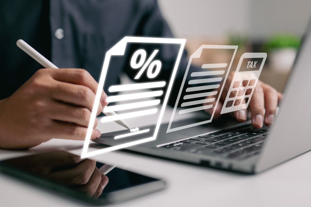 A Person Calculating Percentage And Tax