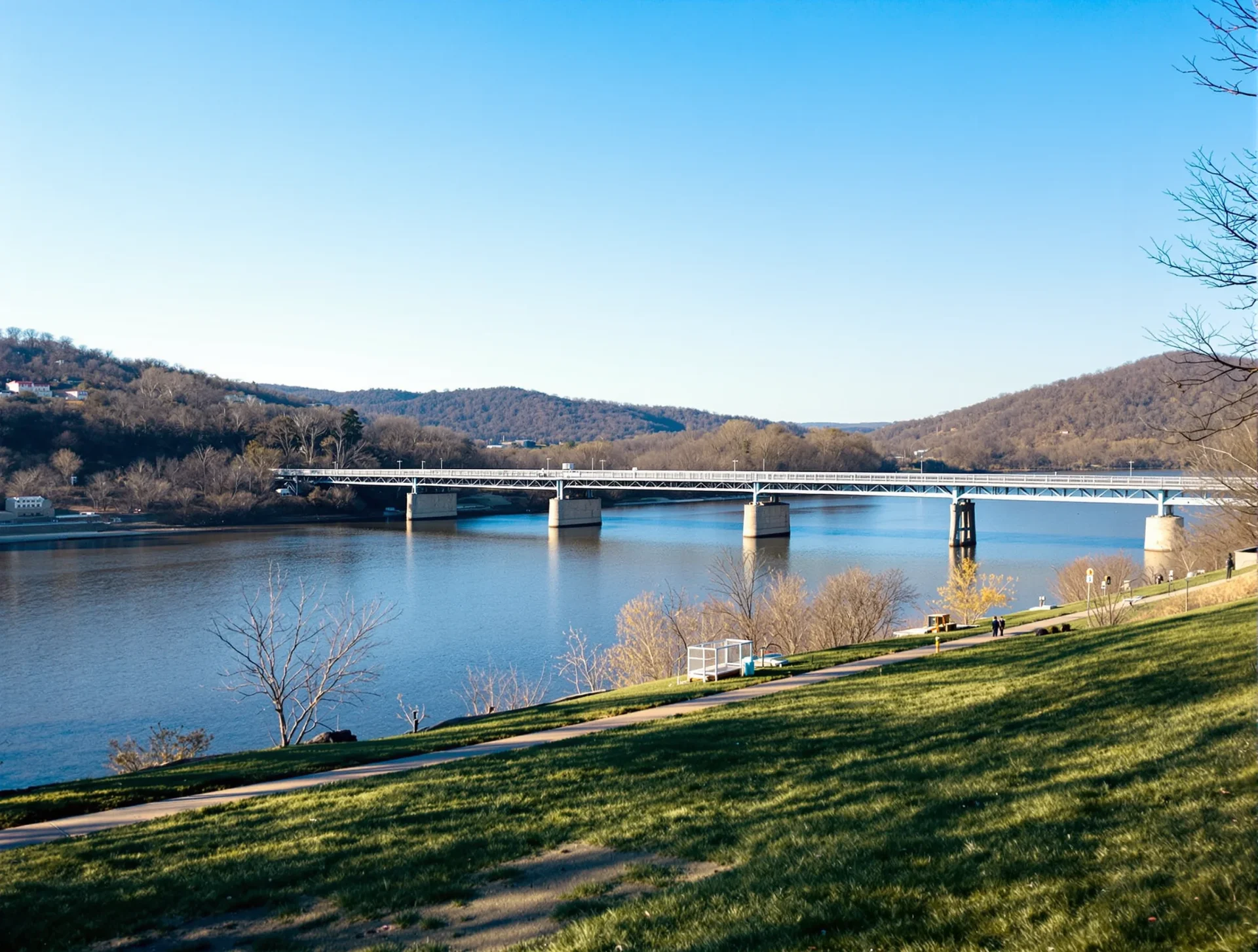 Tennessee River and walking path with views of bridges and hills in Chattanooga, Tennessee