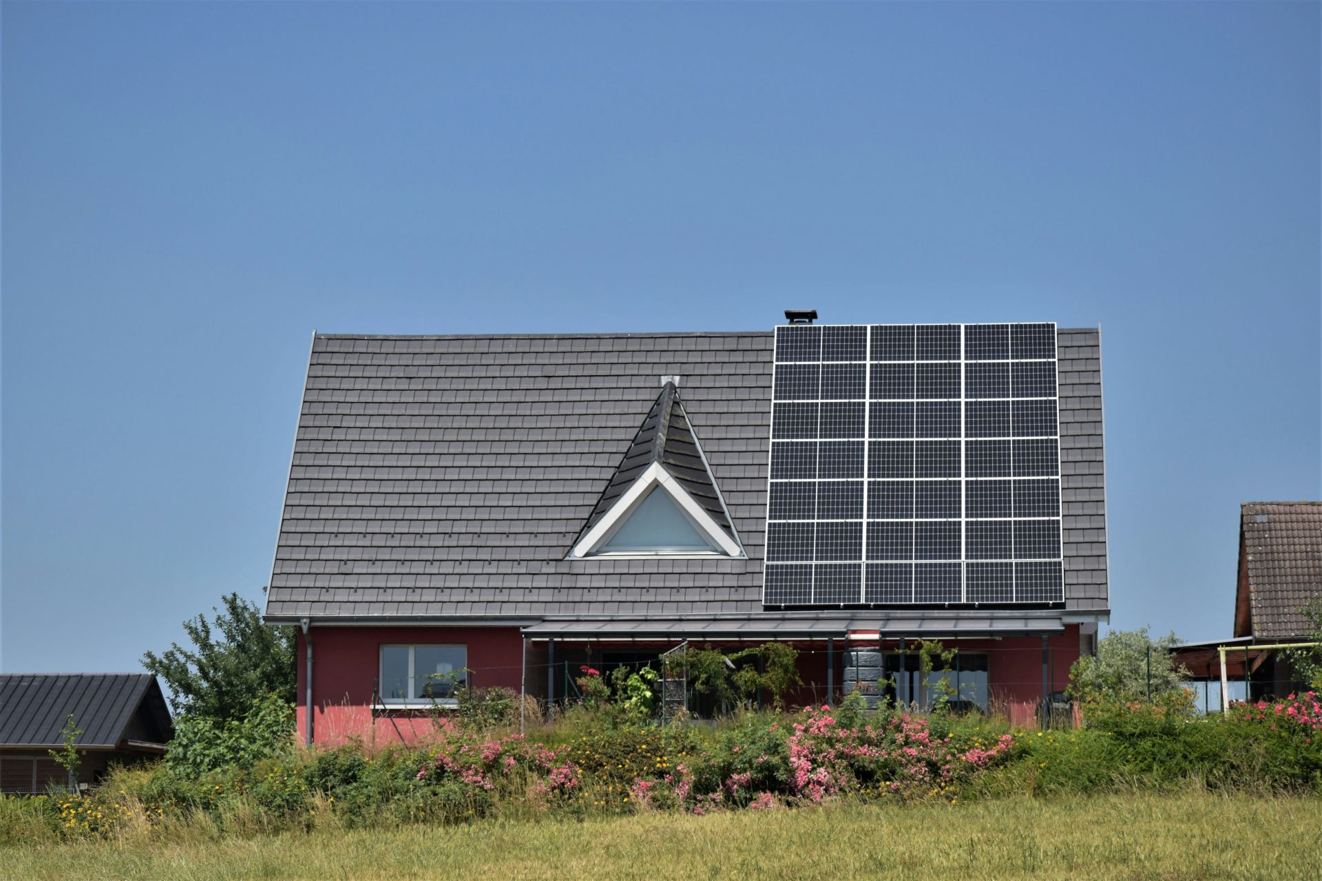a-house-with-a-solar-panel-on-the-roof a house with a solar panel on the roof