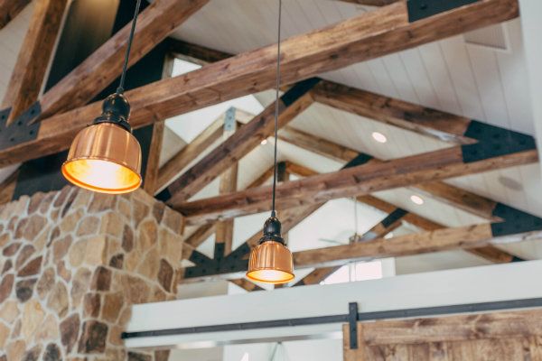 Lights hanging from wood beams on ceiling