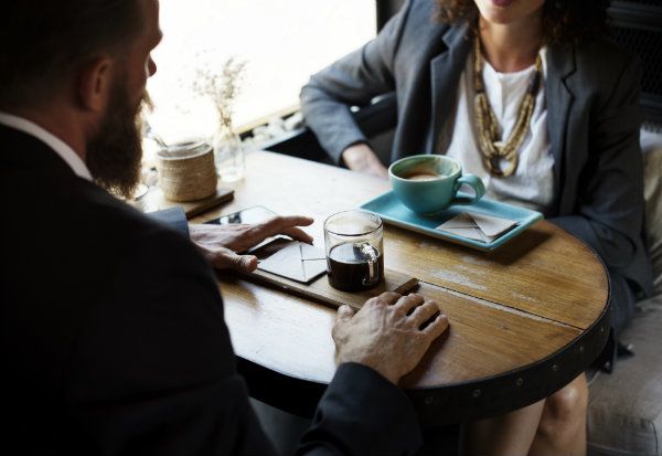 Two People Sitting Down having coffee