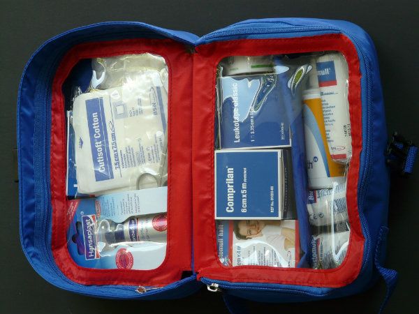 An opened emergency kit filled with tools and supplies