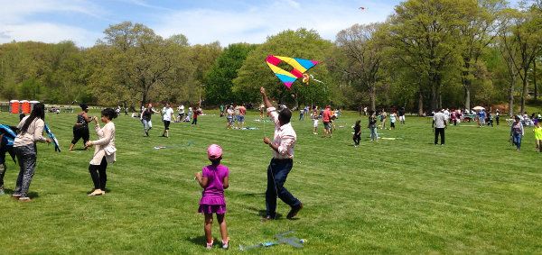 Image of a family flying kites at the KPC Kite Festival in Boston MA