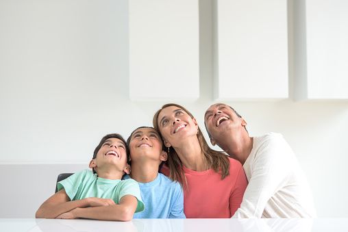 Family thinking and laughing together about kitchen renovations