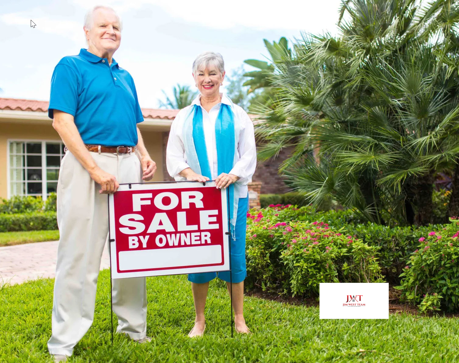 Older couple standing in front of their home with a For Sale by Owner sign in Marysville, Ohio