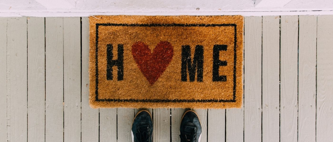 home place mat in front of door