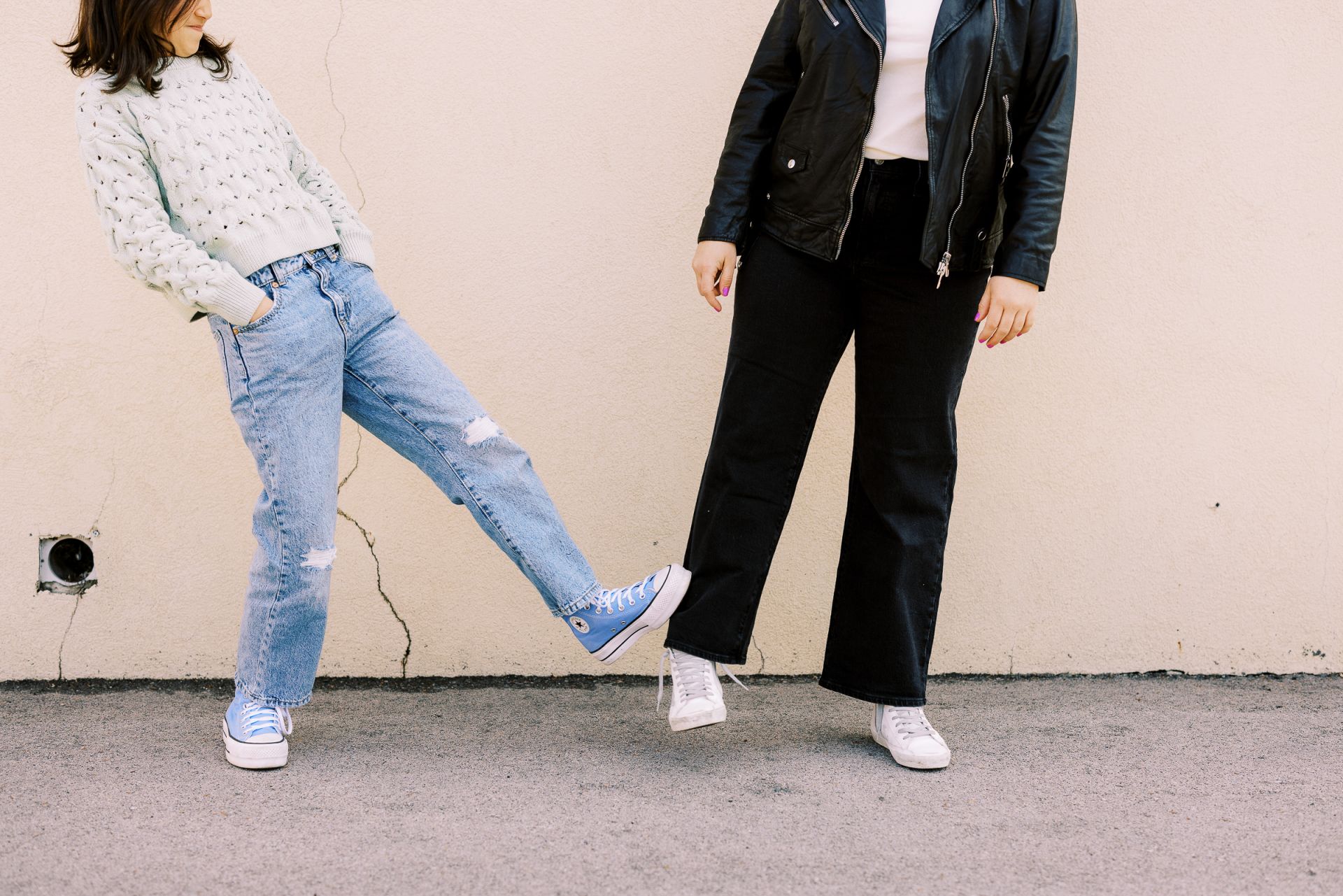 two friends stand in an urban environment
