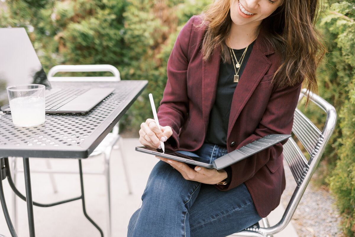 female CPA in Salt Lake City a female accountant works on her laptop as she smiles