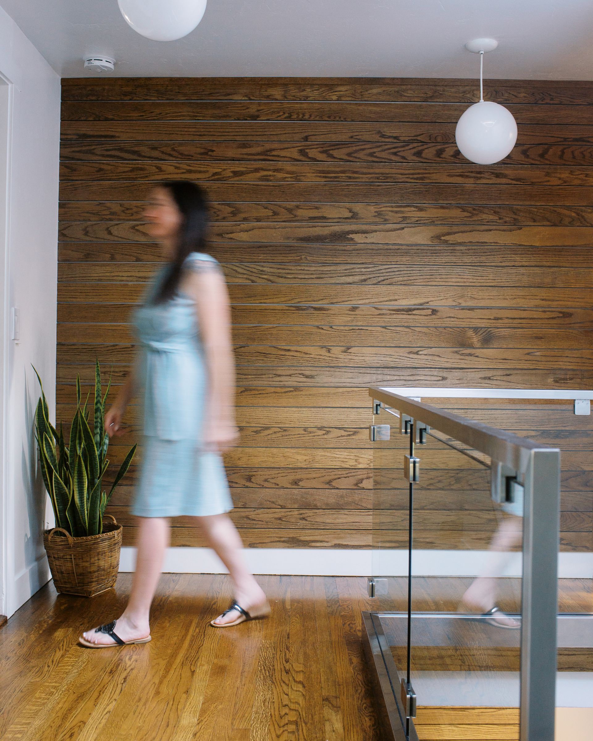 how to sell your home fast a woman walks through a hallway in a modern home