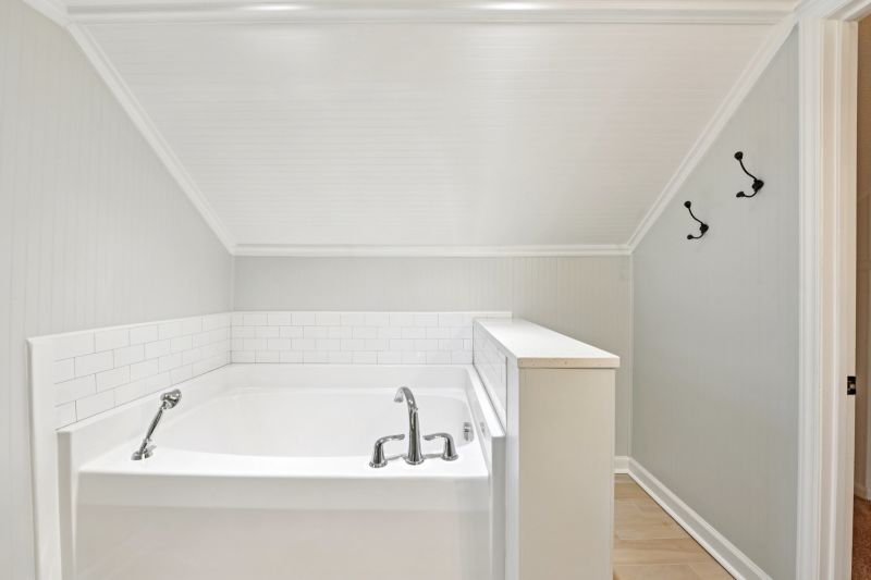 Renovated primary bathroom with tile shower and soaking tub in Concord NC historic bungalow.
