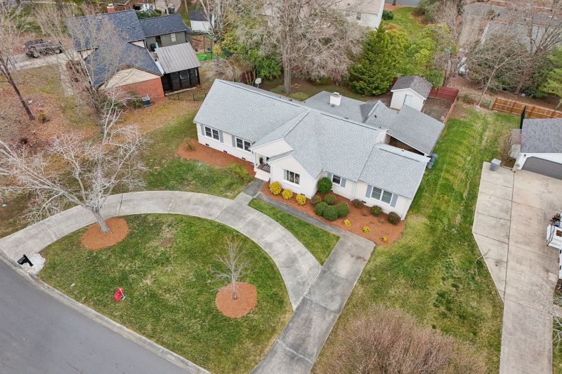 Brick ranch with circular driveway in South Charlotte neighborhood