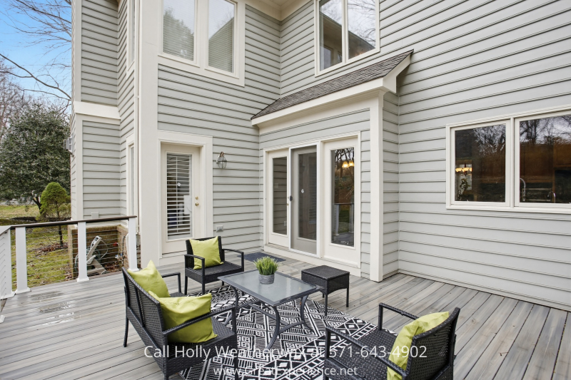 Private outdoor deck at 11316 Bright Pond Lane, Reston, VA featuring seating area, wood decking, and access to the backyard—perfect for relaxing or entertaining.