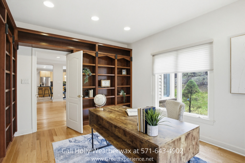 Home office at 11316 Bright Pond Lane, Reston, VA, featuring custom built-in shelving, hardwood floors, and large window with natural light.