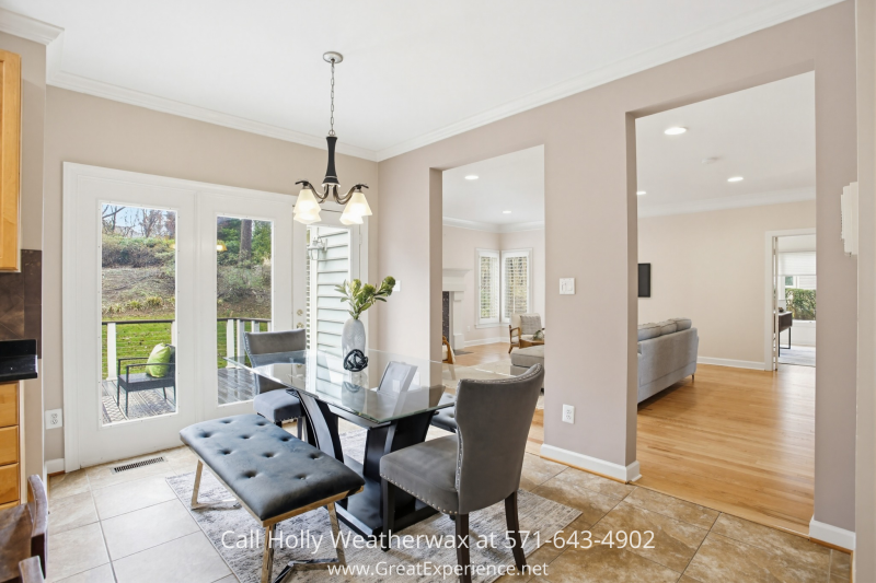 Bright breakfast area at 11316 Bright Pond Lane, Reston, VA with glass table, natural light, and French doors opening to the outdoor deck.