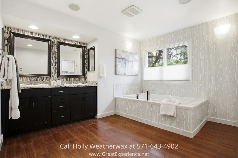 Spa-like primary bathroom at 11316 Bright Pond Lane, Reston, VA featuring a soaking tub, double vanity, and modern finishes with natural light.