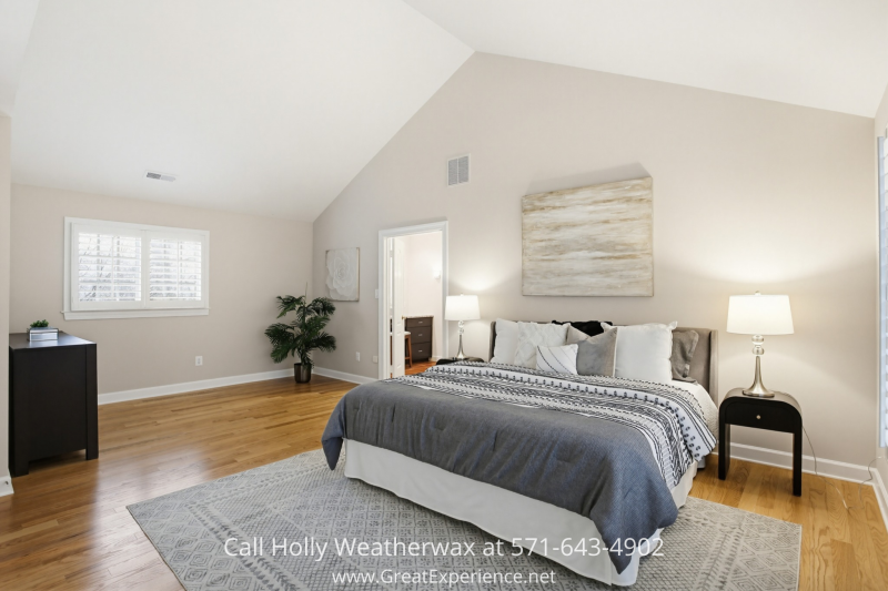 Spacious primary bedroom at 11316 Bright Pond Lane, Reston, VA featuring vaulted ceilings, hardwood floors, and a serene, light-filled layout.