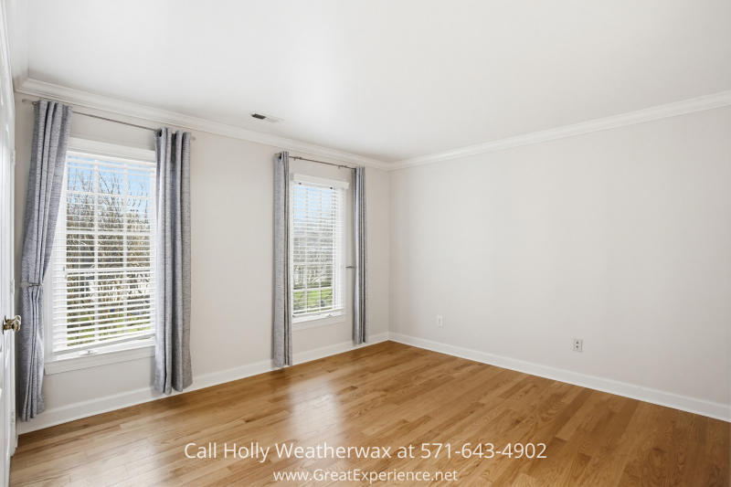 Bright secondary bedroom at 11316 Bright Pond Lane, Reston, VA featuring hardwood floors, large windows, and abundant natural light.
