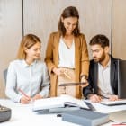 About me inception-app-prod/YmI4ZWFlZWEtNjUyZC00NjRhLTlkNTgtY2M2MGUyYzEwNzRi/content/2021/09/Smallgroupofcreativeofficeemployeesworkingtogetheronsomearchitecturalprojectinthemodernoffice.Conceptofanarchitecturalbusinessandcreativework.jpg