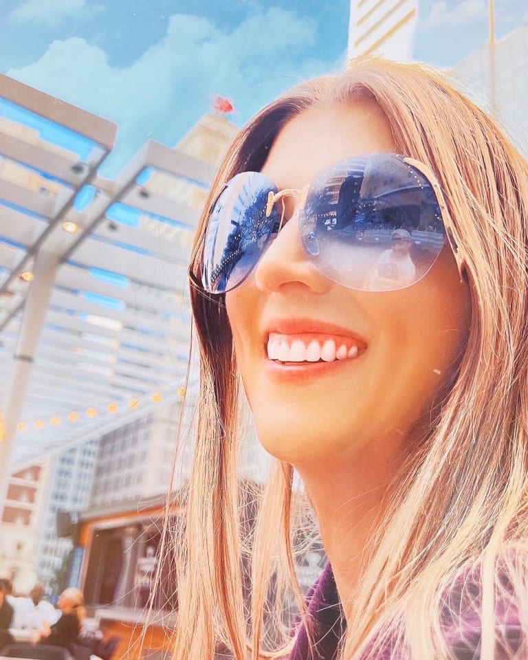 Alternate crop of Steavy Carter in blue sunglasses with gold frames — lighthearted and fresh brand energy.
