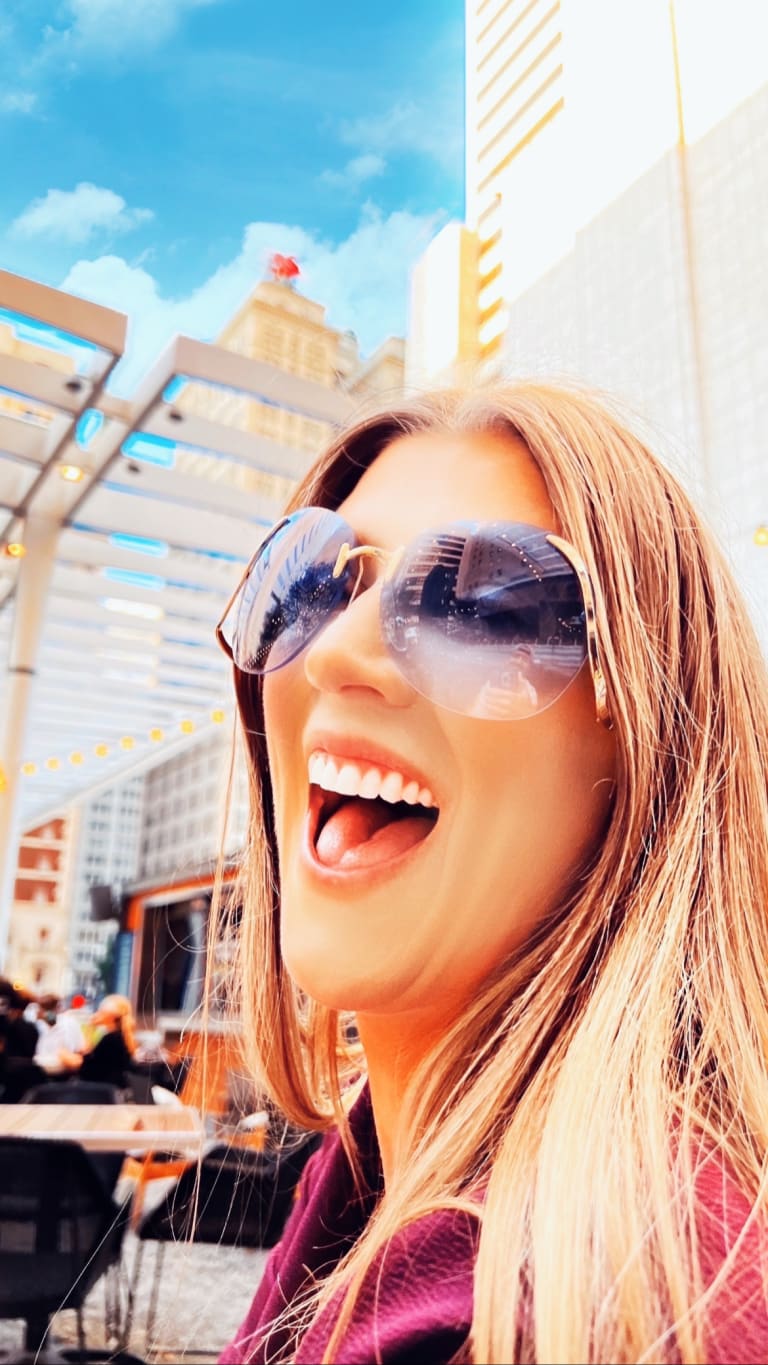 Alternate crop of Steavy Carter in vintage sunglasses laughing at the AT&T Discovery District — candid and joyful marketing image.