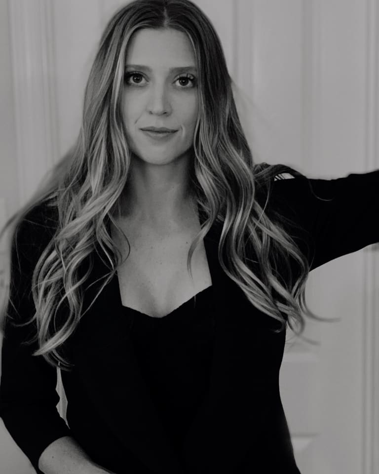 Steavy Carter with a sultry, confident gaze, wearing a black dress — striking branding image with strong eye contact.