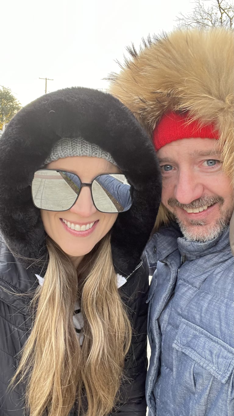 Sean and Steavy bundled in winter coats with fur-lined hoods — cozy and festive seasonal snapshot.