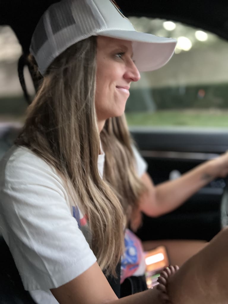 Steavy Carter wearing a hat while driving a Jeep — adventurous real estate personality on the move.