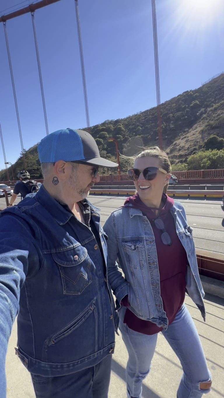 Sean and Steavy Carter walking across the Golden Gate Bridge, looking at each other — iconic and connected branding moment.