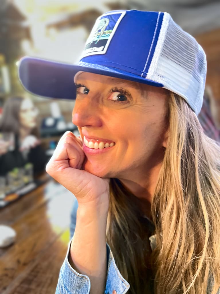 Steavy Carter laughing in the same blue hat — playful and fun-loving personality shot.