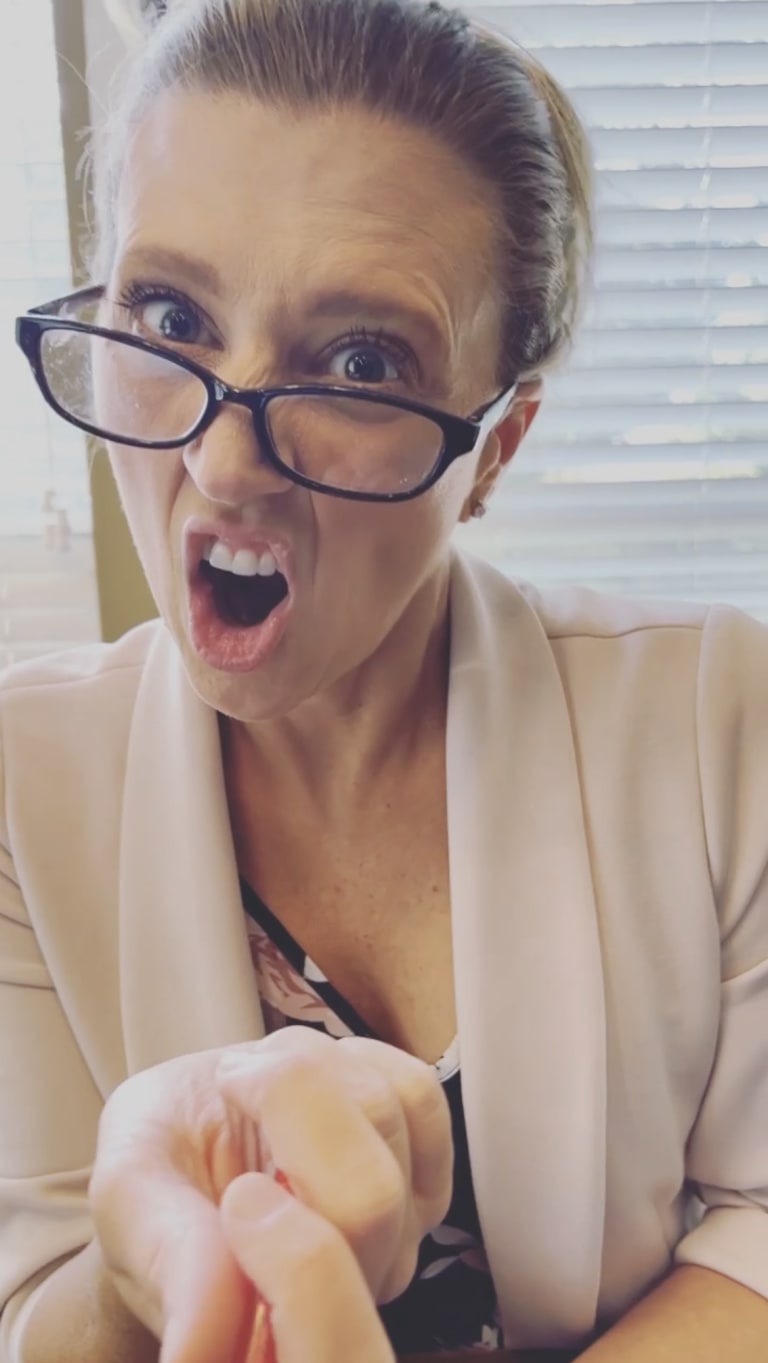 Steavy Carter making a funny face in glasses and a pink blazer — personality-forward branding with charm and humor.