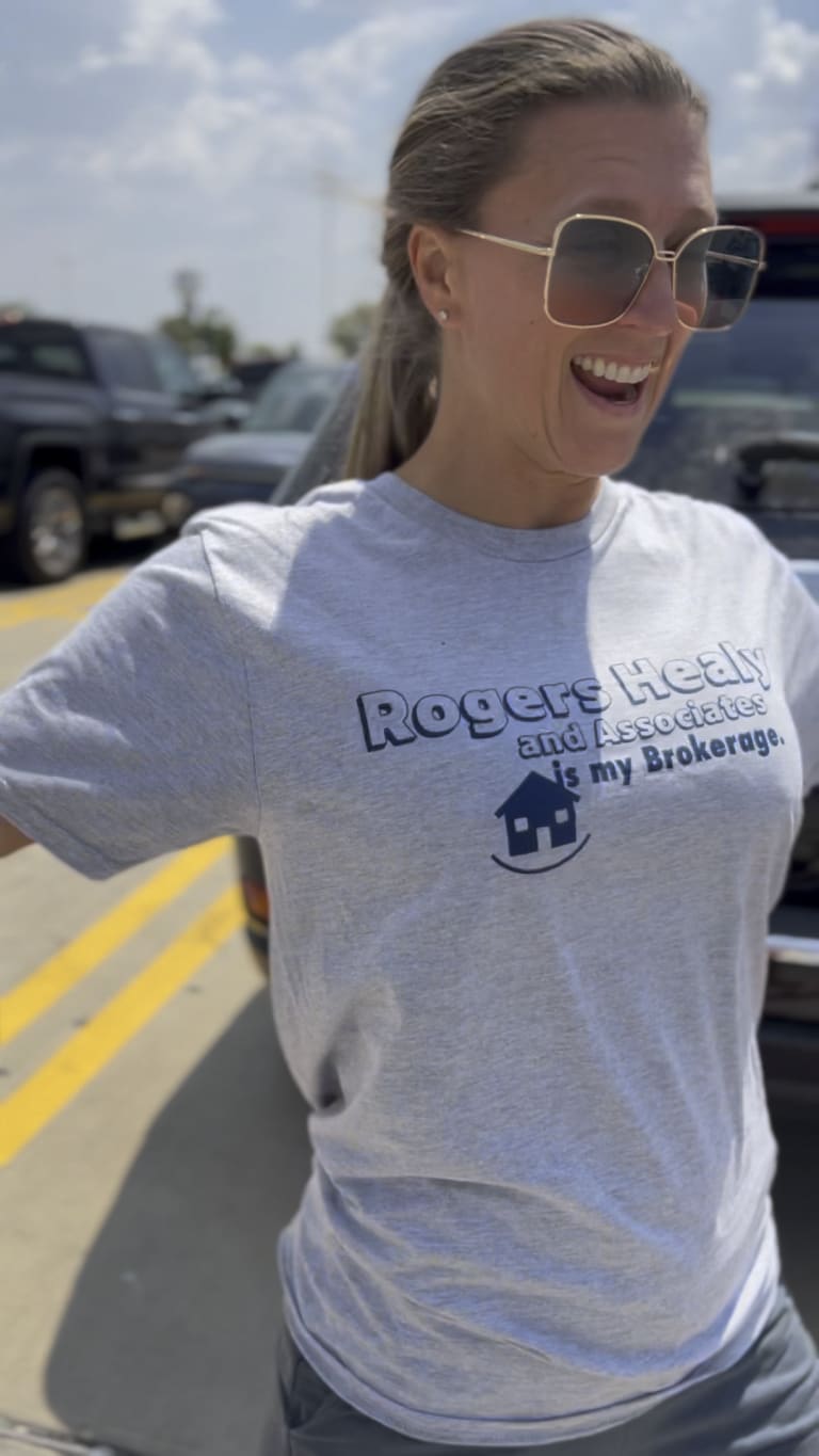Steavy Carter laughing in a 'Rogers Healy Is My Realtor' T-shirt — fun and personal real estate branding.