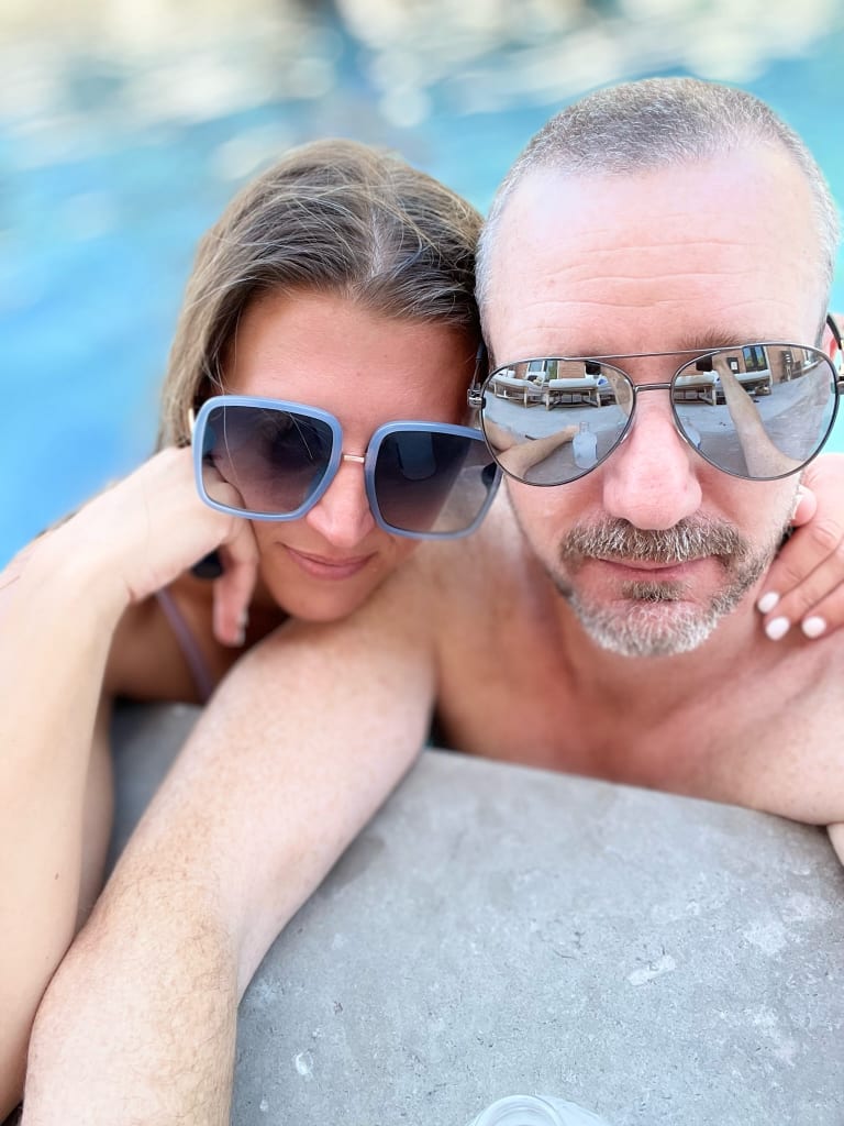 Serious-faced poolside photo of Sean and Steavy — stylish and composed outdoor shot.