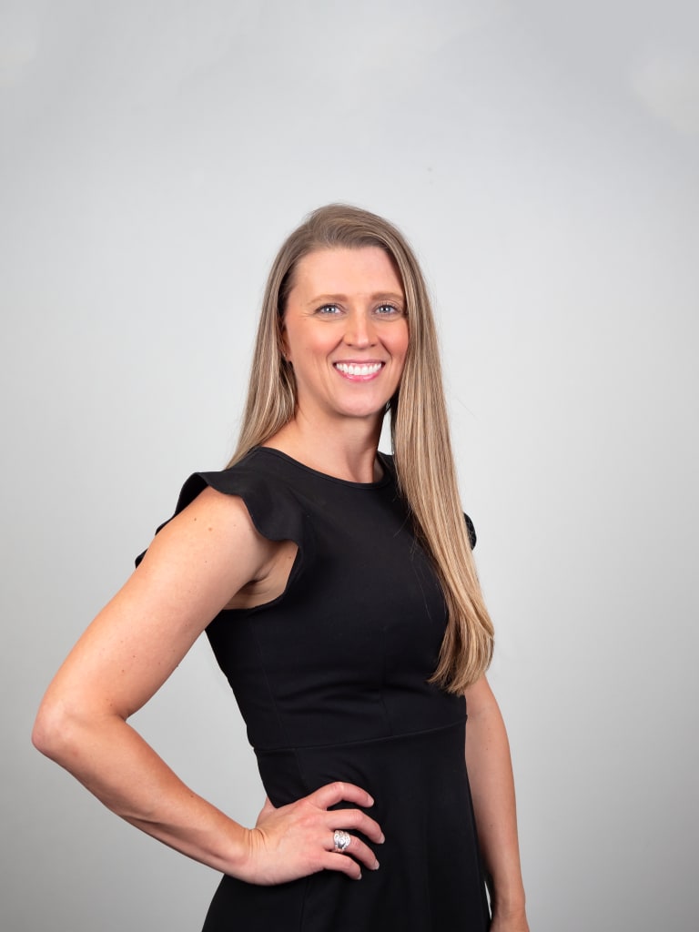 Steavy Carter in a black dress with sleek, straight hair — clean and modern headshot for professional branding.