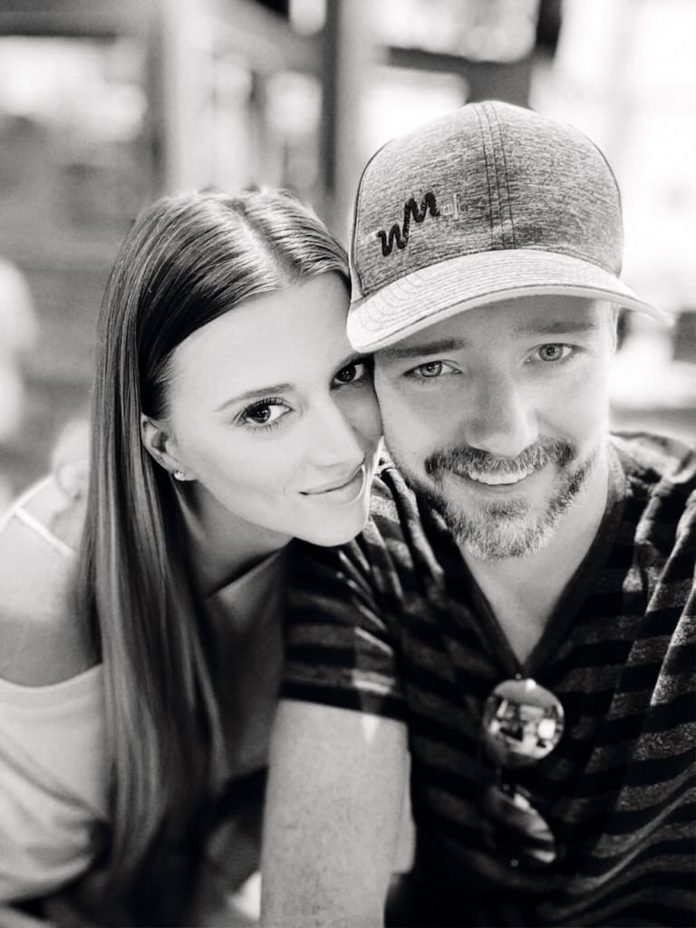 Steavy leaning into Sean while he smiles — affectionate and playful couple photo.