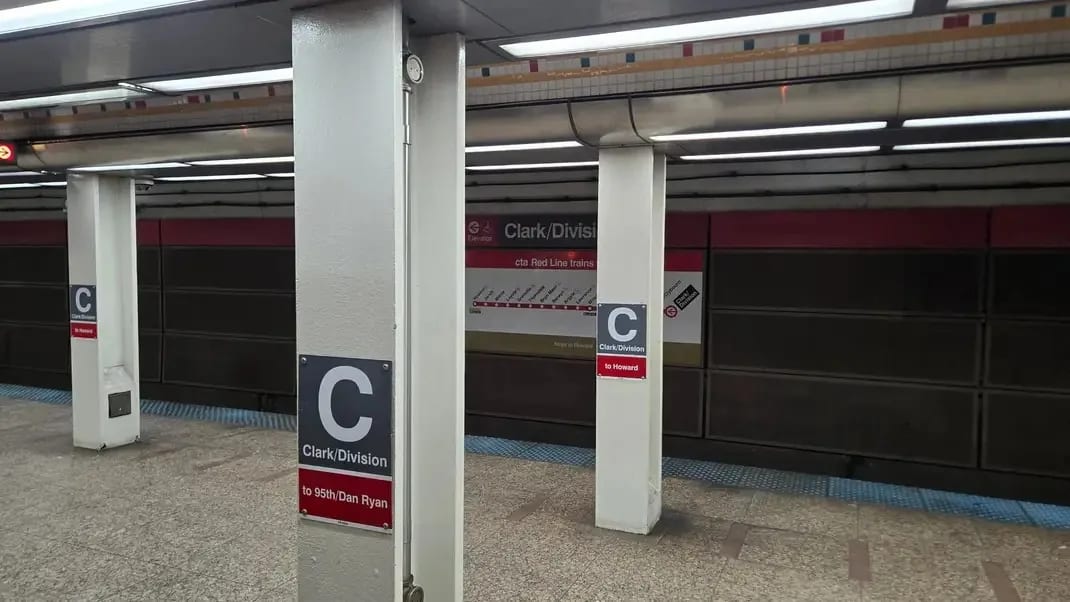 Clark/Division Red Line subway platform with a train arriving on Chicago's Gold Coast