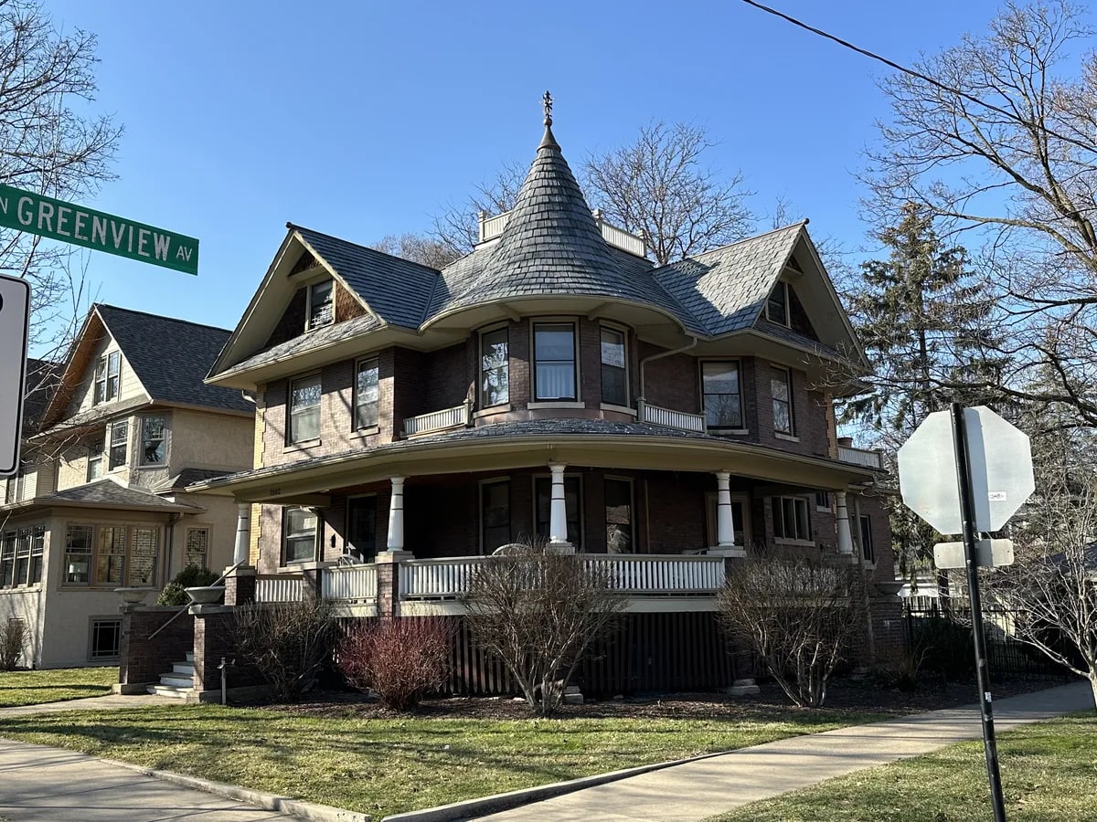 Queen Anne house with a conical corner turret and wraparound porch in Edgewater Glen, Chicago