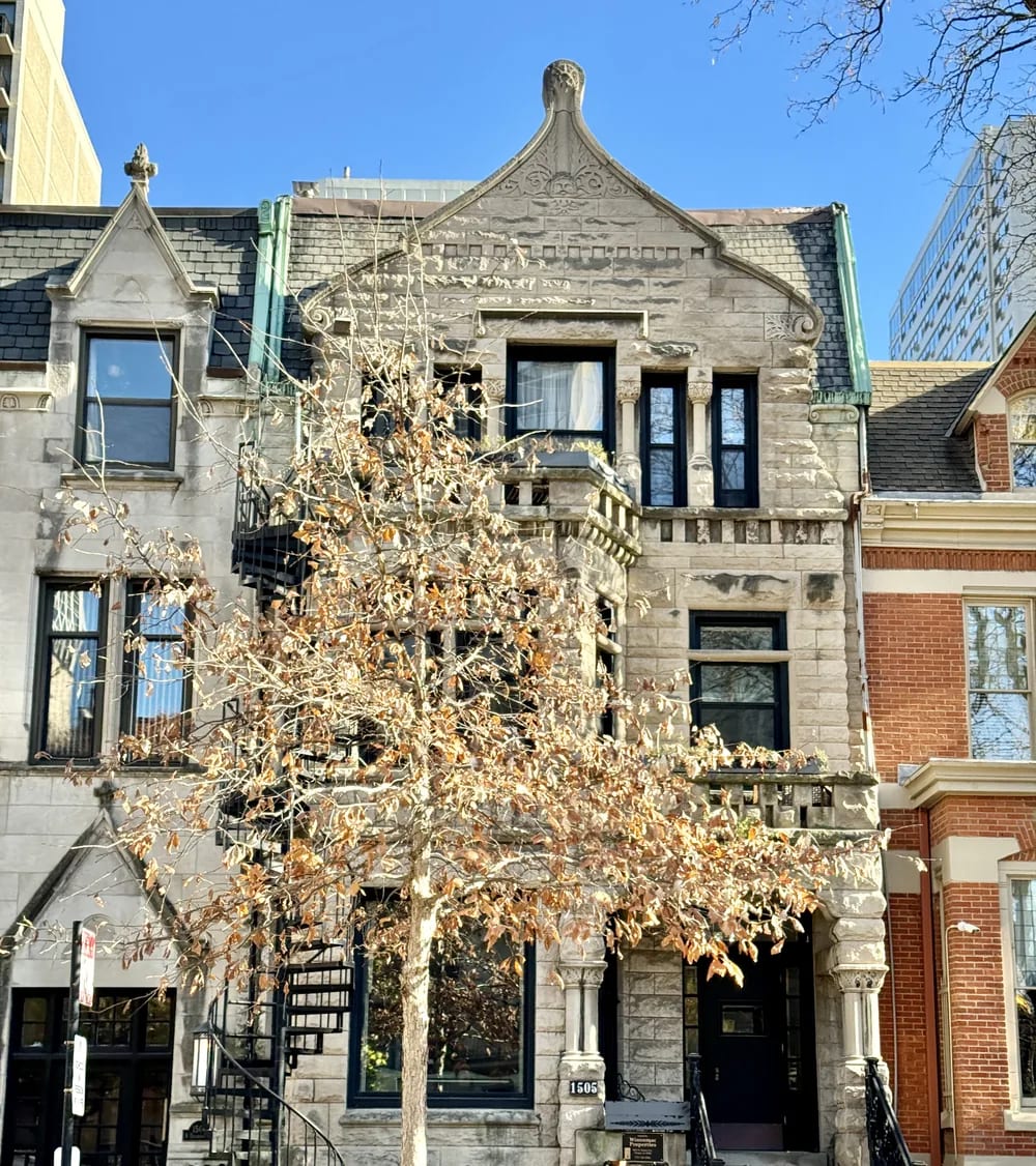 Rough-cut stone rowhouse with a steep front gable on Dearborn Street in the Gold Coast, Chicago