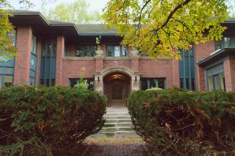 Brick house with an arched stone entry by architect George W. Maher in the Hutchinson Street District, Chicago's Buena Park