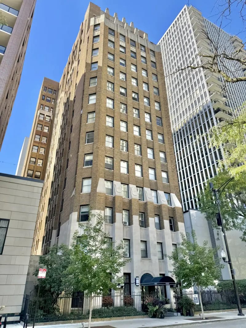Art Deco high-rise in buff brick with a limestone base and arched entrance canopy on State Parkway in the Gold Coast, Chicago