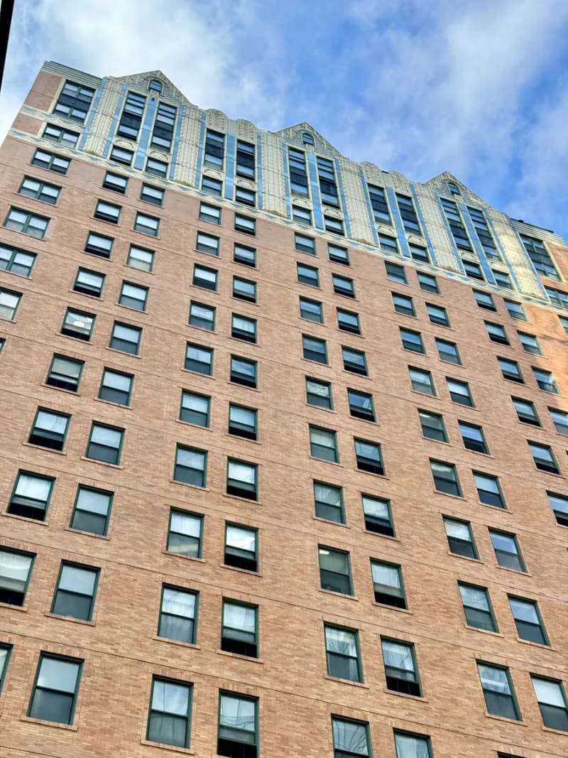 Red brick high-rise with decorative terra cotta trim and gables at the top, at State and Elm streets in the Gold Coast, Chicago