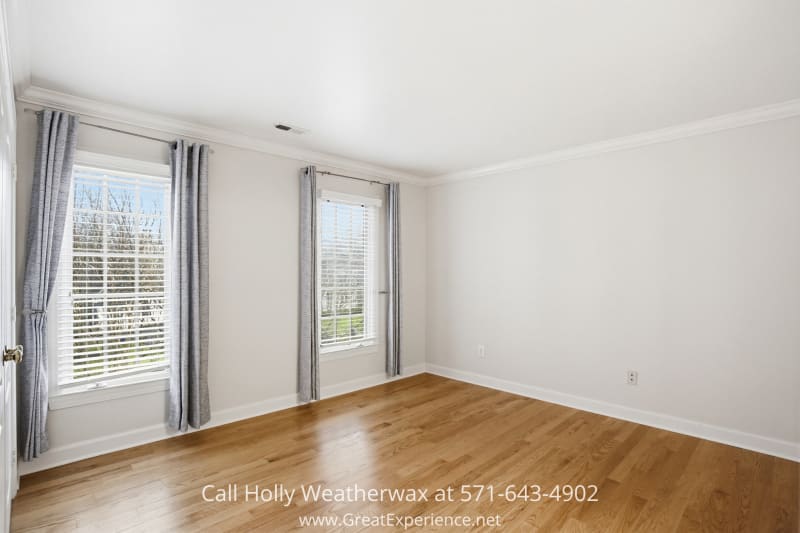 11316 Bright Pond Lane 10 Bright secondary bedroom at 11316 Bright Pond Lane, Reston, VA featuring hardwood floors, large windows, and abundant natural light.